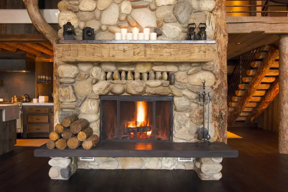Cozy Gatlinburg cabin hearth with fireplace and wooden bench in the Smoky Mountains
