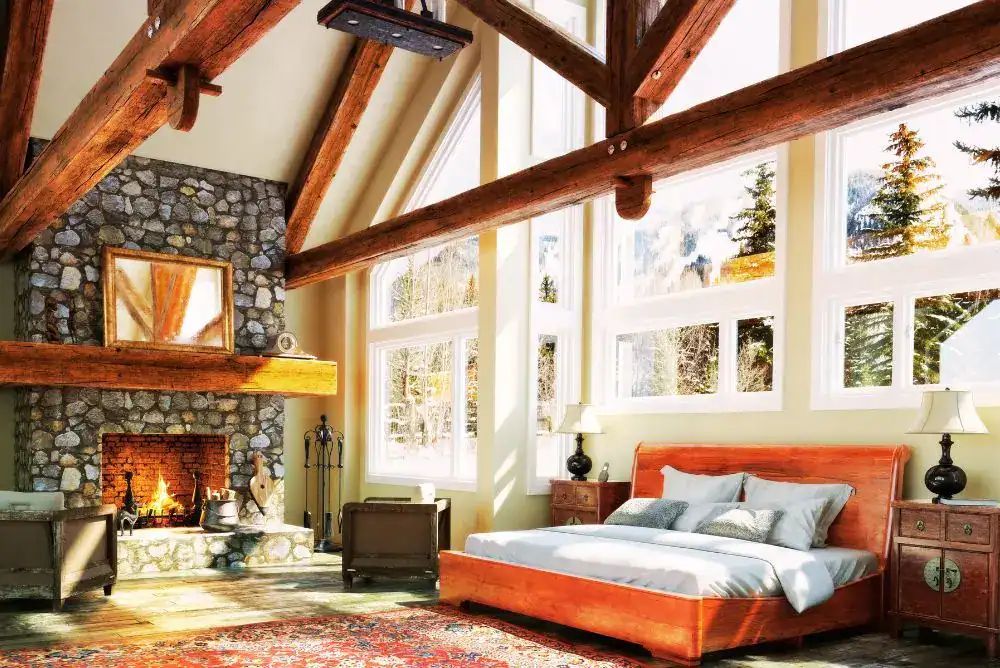 Warm Pigeon Forge cabin bedroom with rustic fireplace for a Smoky Mountain getaway