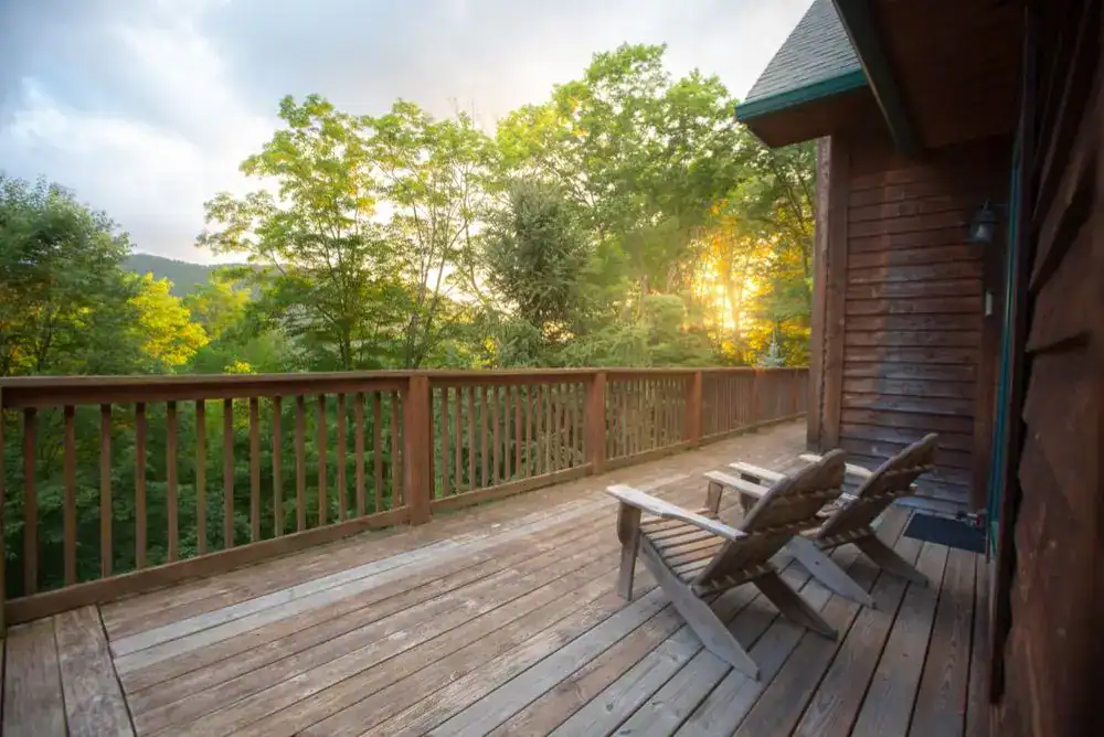 Cozy Pigeon Forge cabin porch with sunset views over the Smoky Mountains