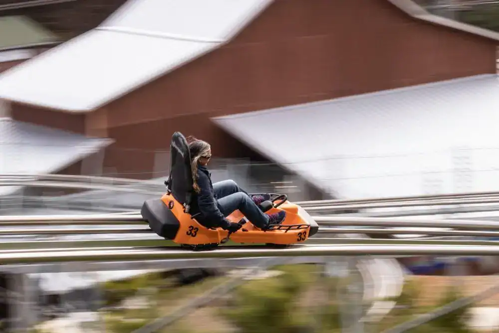 Riding down the Rocky Top Mountain Coaster in Pigeon Forge, one of the most popular Smoky Mountain coasters to ride in the fall.