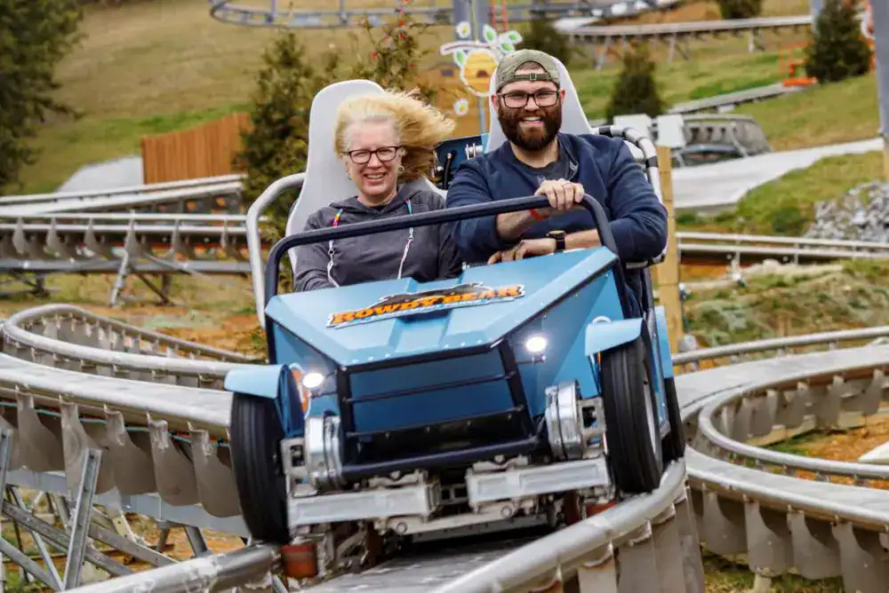 Rowdy Bear Mountain Coaster in Pigeon Forge with riders enjoying one of the most exciting Smoky Mountain coasters.