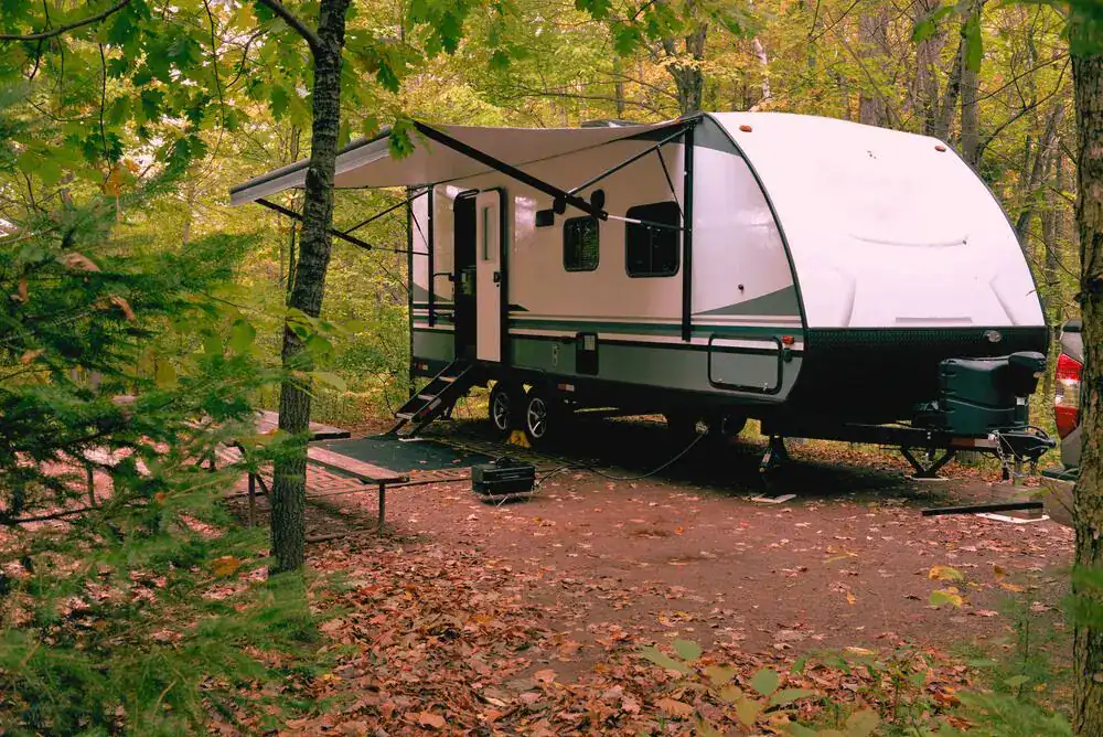 Travel trailer at a wooded campsite in Cades Cove Campground in the Great Smoky Mountains.