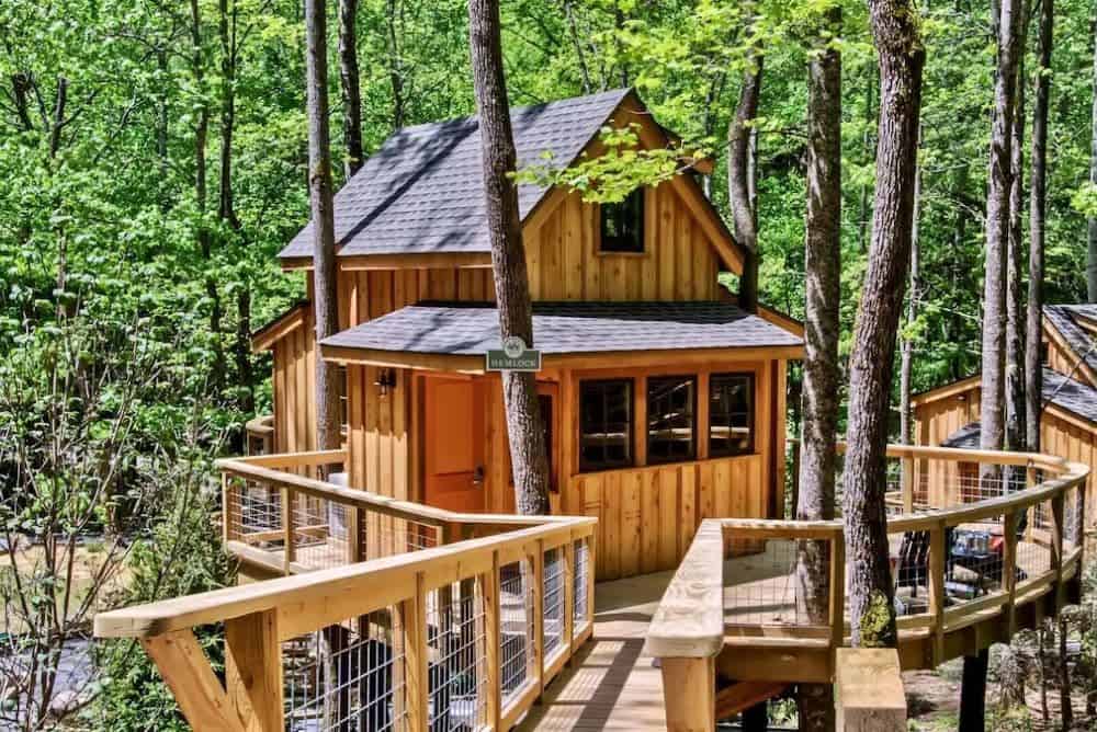 Cozy treehouse surrounded by trees in the Great Smoky Mountains, a peaceful glamping stay with mountain views.