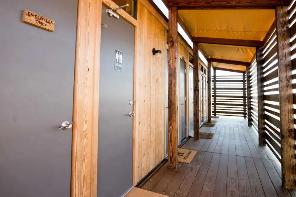 Private bathhouse with shower and toilet at Under Canvas Smoky Mountains