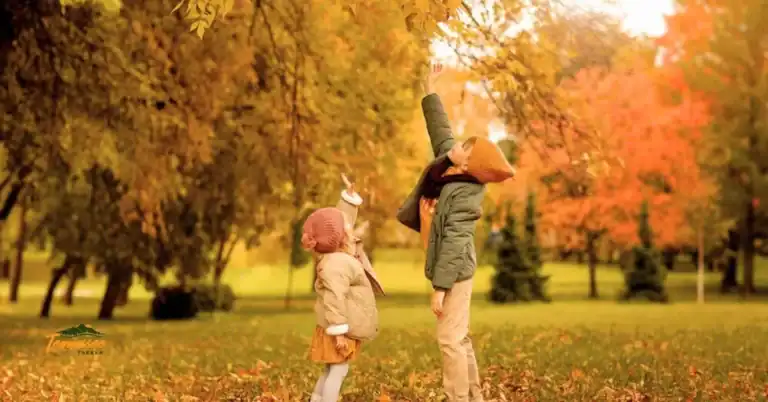 Kids enjoying a fall day outdoors during a fun Fall Scavenger Hunt for Kids in Tennessee, collecting leaves and exploring nature together.