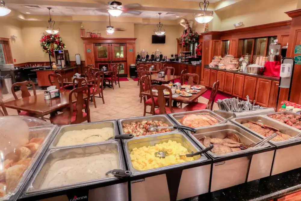 Breakfast buffet at The Inn at Christmas Place in Pigeon Forge featuring omelets, biscuits, and pastries.