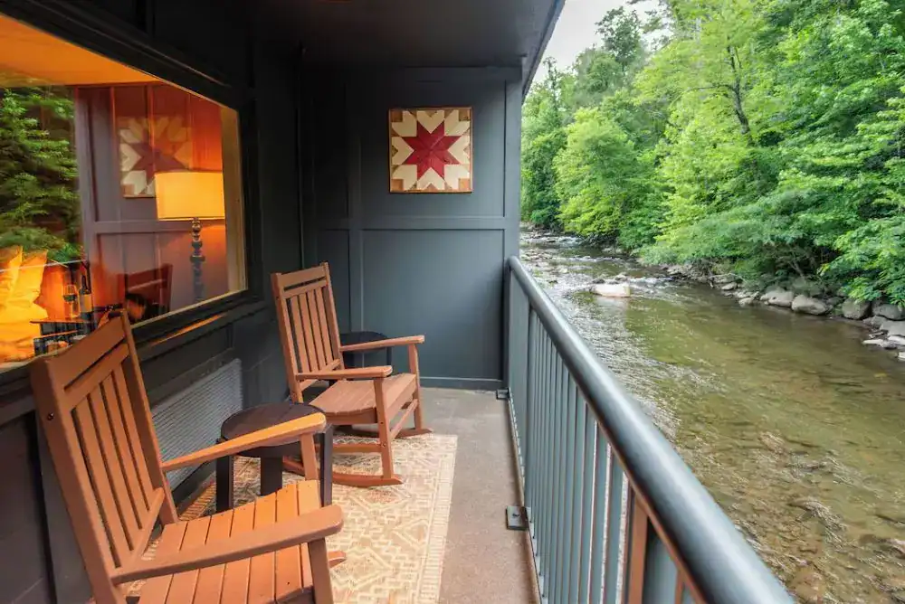 Private riverfront balcony at Rocky Waters Inn Gatlinburg overlooking the Little Pigeon River