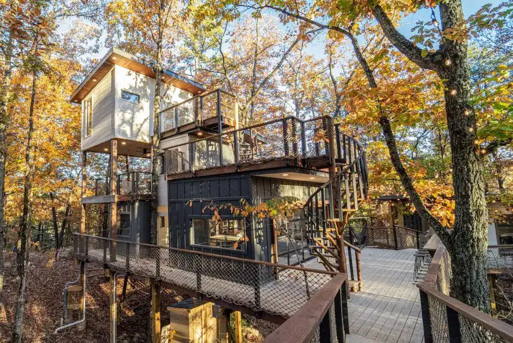 Luxury treehouse stay near Dollywood with four connected treehouses surrounded by Smoky Mountain forest views.