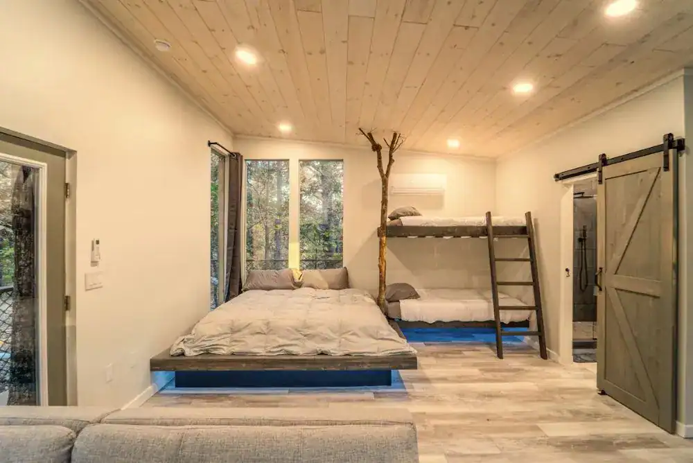 Treehouse bedrrom with full bed and bunks. 