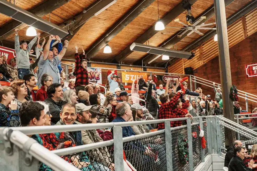 Crowd at dinner show in Pigeon Forge cheering. 