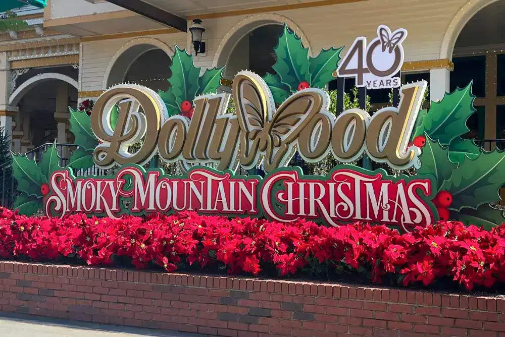 Dollywood entrance sign decorated for Smoky Mountain Christmas in Pigeon Forge TN - grab your tickets!