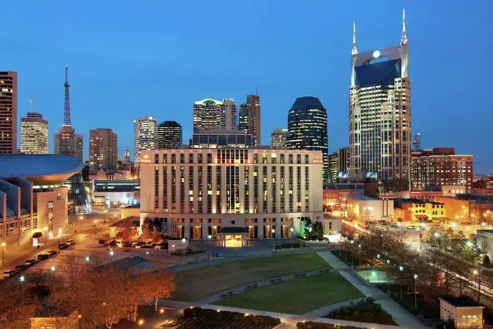 Evening view of Nashville TN hotels and downtown skyline, showing popular places to stay in Nashville Tennessee. 