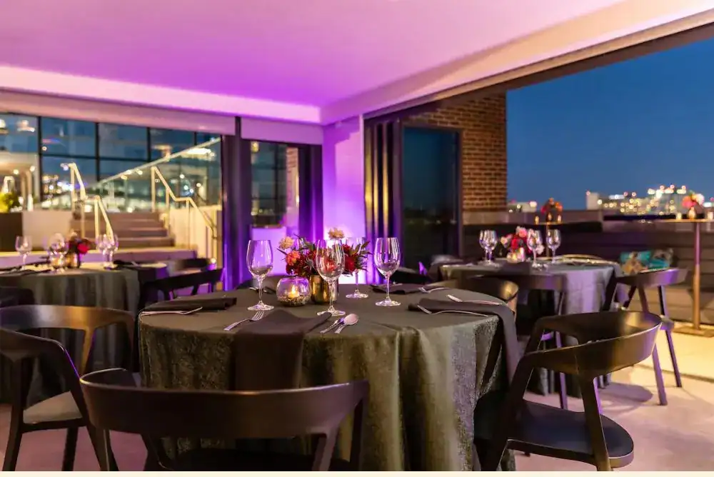 Dining table set at restaurant with city views. 