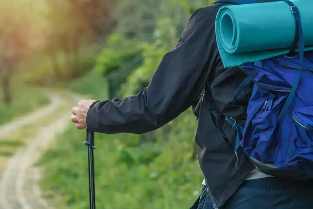 Backpacker hiking in the Mountains - backcountry options for camping in the park