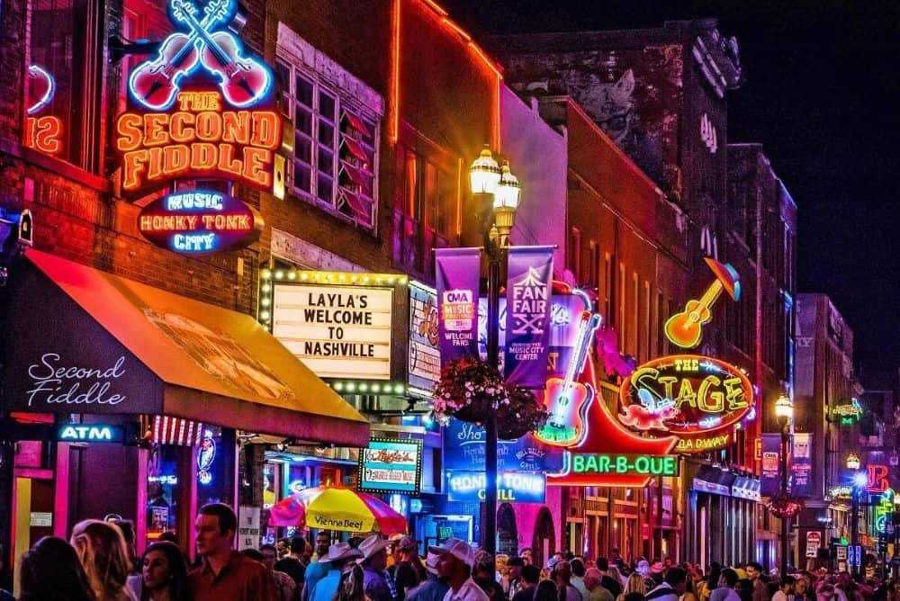 Downtown Nashville Broadway at night with live music bars and neon lights