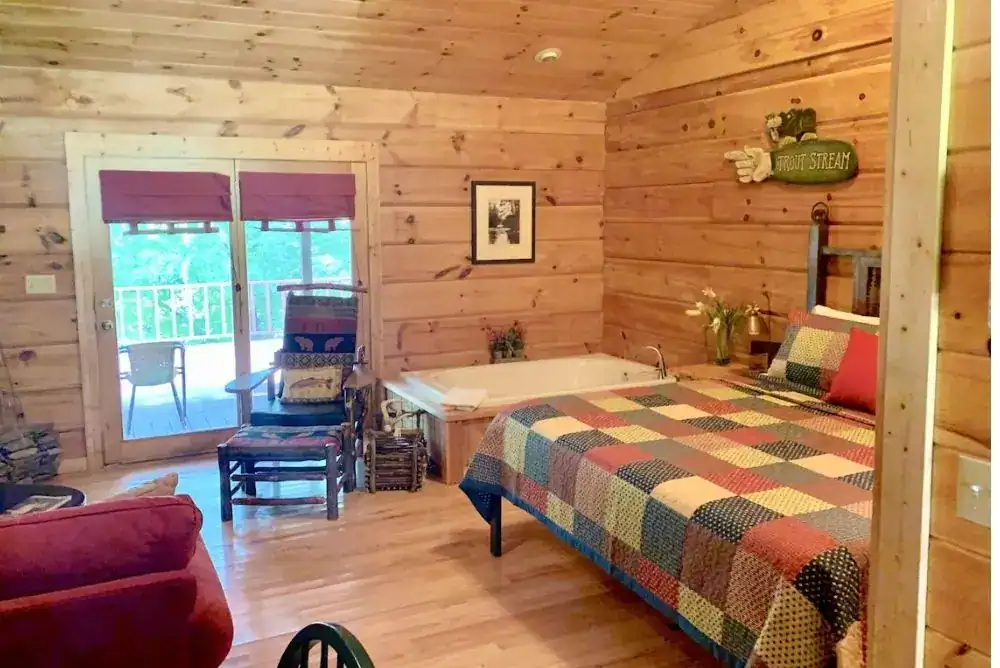 Riverside cabin bedroom in Townsend TN with a large tub for a romantic couples stay