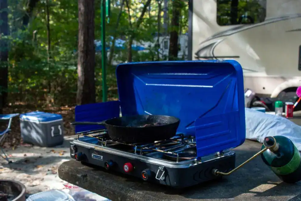 Portable camp stove cooking at a campsite 