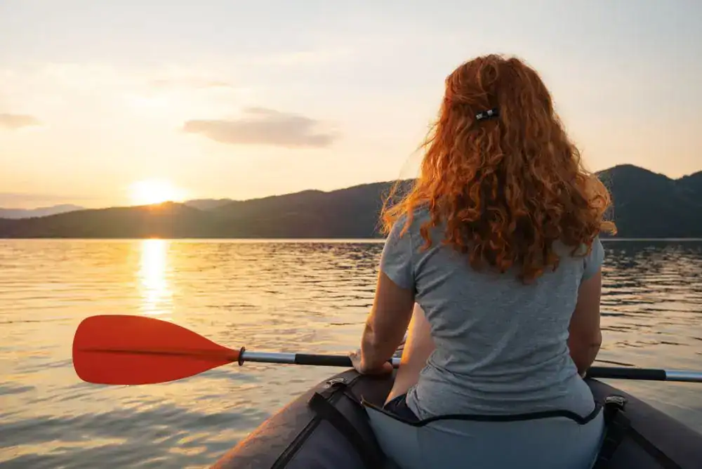 Kayaking on a Tennessee lake at sunset near waterfront campgrounds.