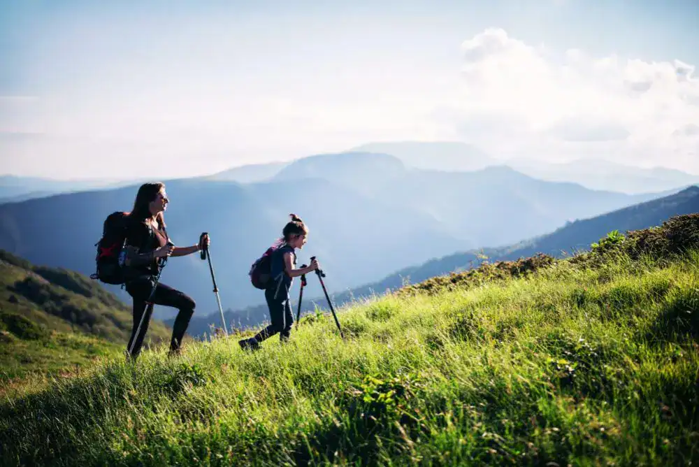 mom and daughter hiking up side of a mountain at a Tennessee state park. 