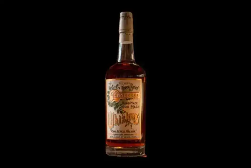 Nelson's Green Brier Tennessee whiskey bottle on a black background.