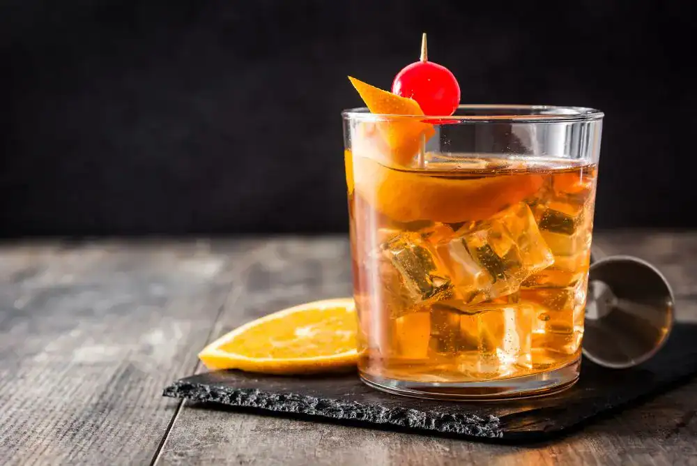 A Tennessee Old Fashioned cocktail with an orange garnish and cherry, made with Tennessee whiskey - featured in our guide