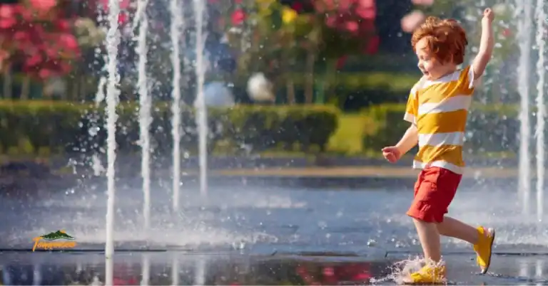 Young child playing in splash fountains at a Chattanooga park, a fun outdoor activity and one of the best things to do with kids on a Tennessee family trip
