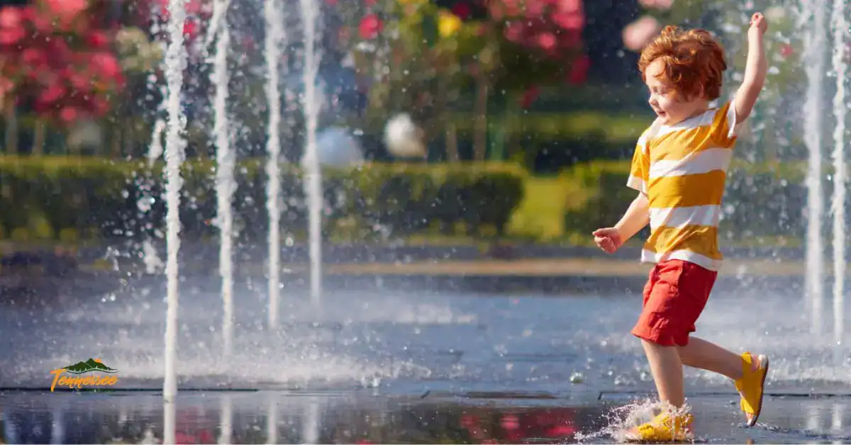 Young child playing in splash fountains at a Chattanooga park, a fun outdoor activity and one of the best things to do with kids on a Tennessee family trip