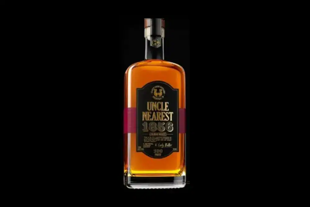 Uncle Nearest 1856 Premium Tennessee whiskey bottle on a black background.