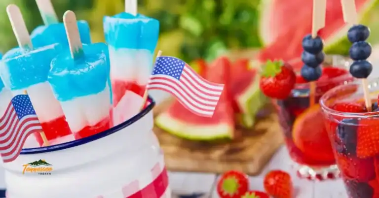 Easy July 4th drinks for kids with red, white and blue layered drinks, patriotic popsicles, fresh berries, and American flags.