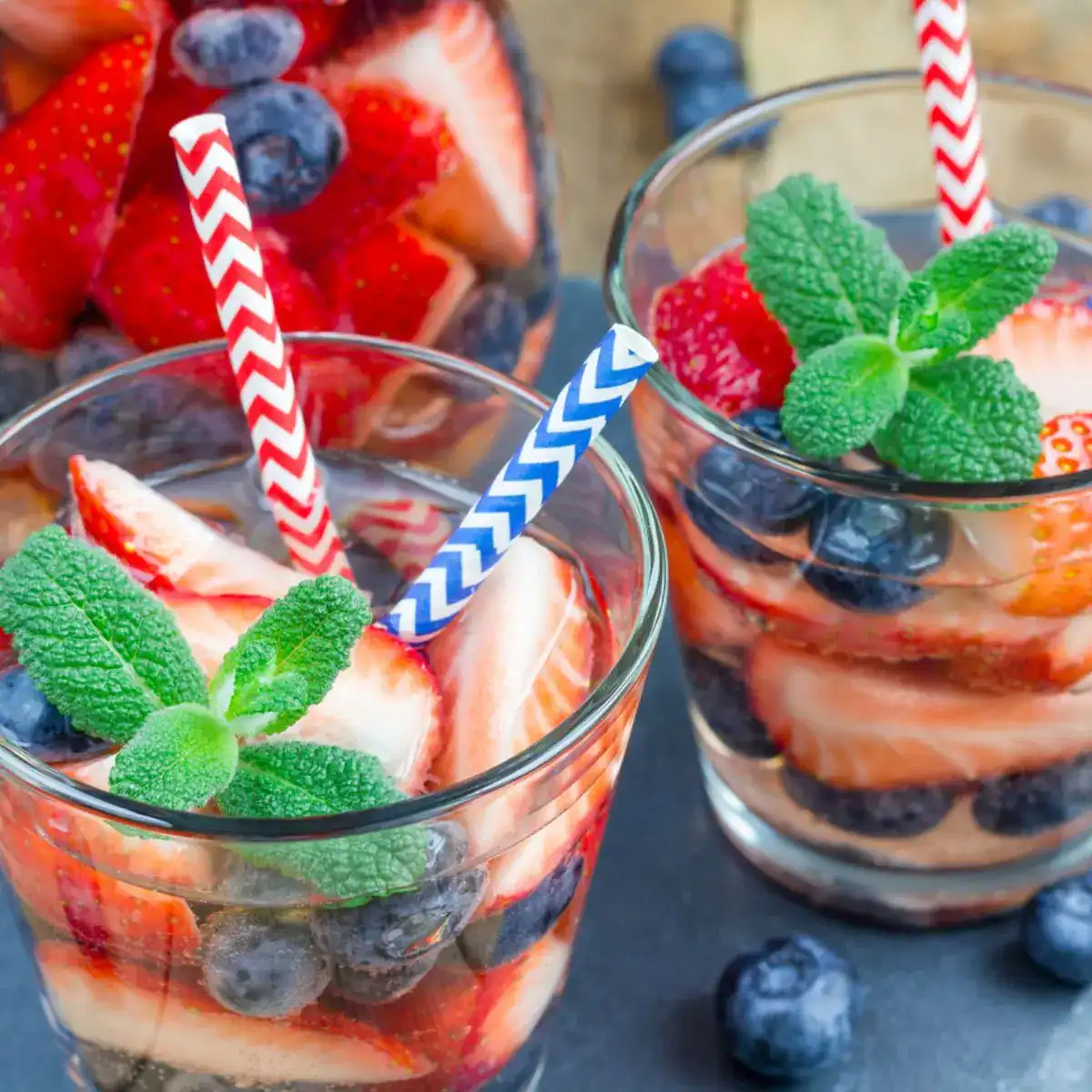 July 4th lemonade drink with strawberries and blueberries.