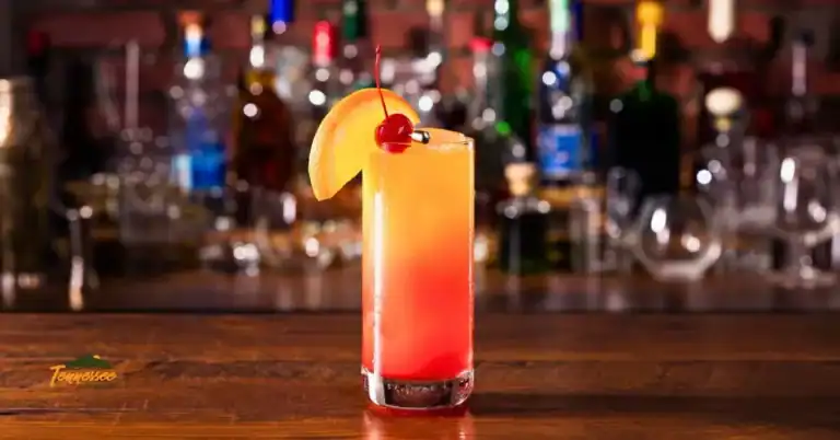 Smoky Mountain Sunset Peach Whiskey Cocktail in a tall glass.