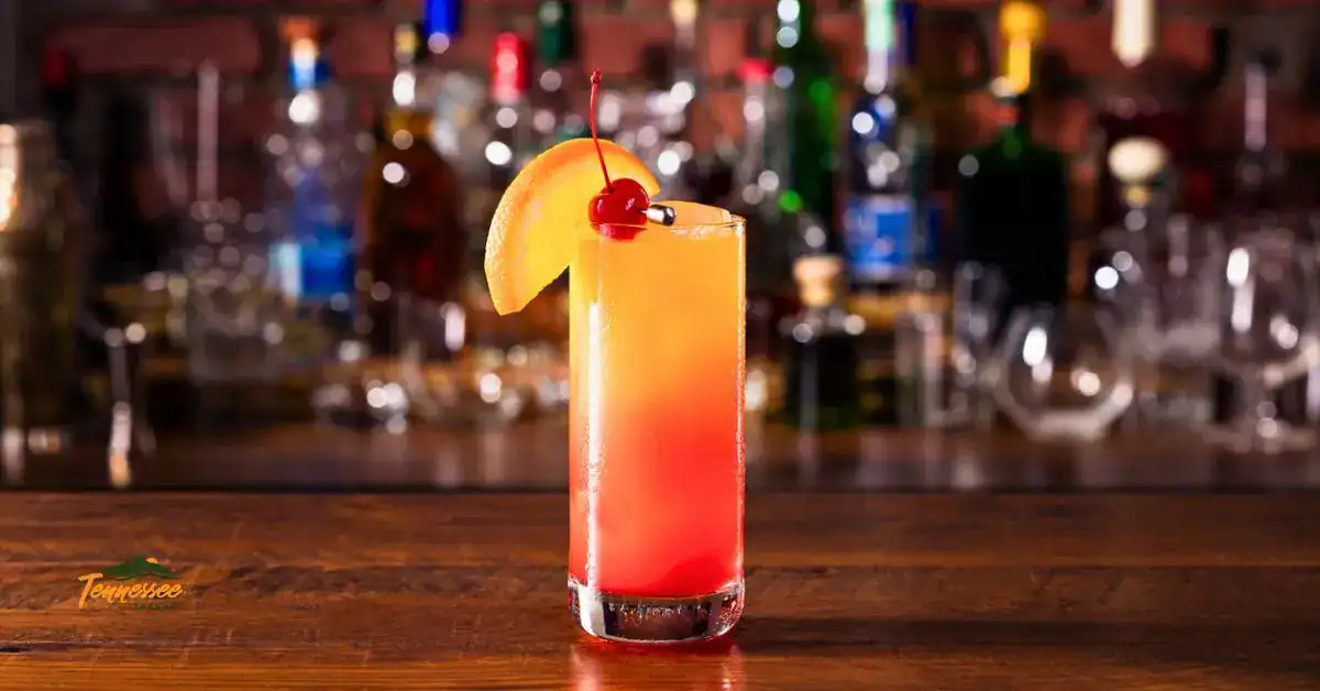 Smoky Mountain Sunset Peach Whiskey Cocktail in a tall glass.