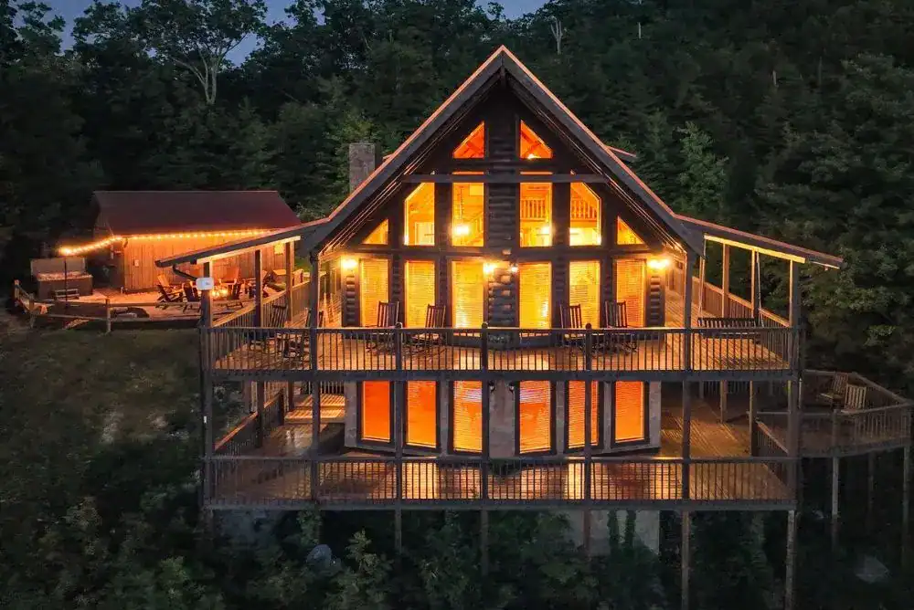 A-frame cabin lit up at dusk in the Smoky Mountains near Pigeon Forge