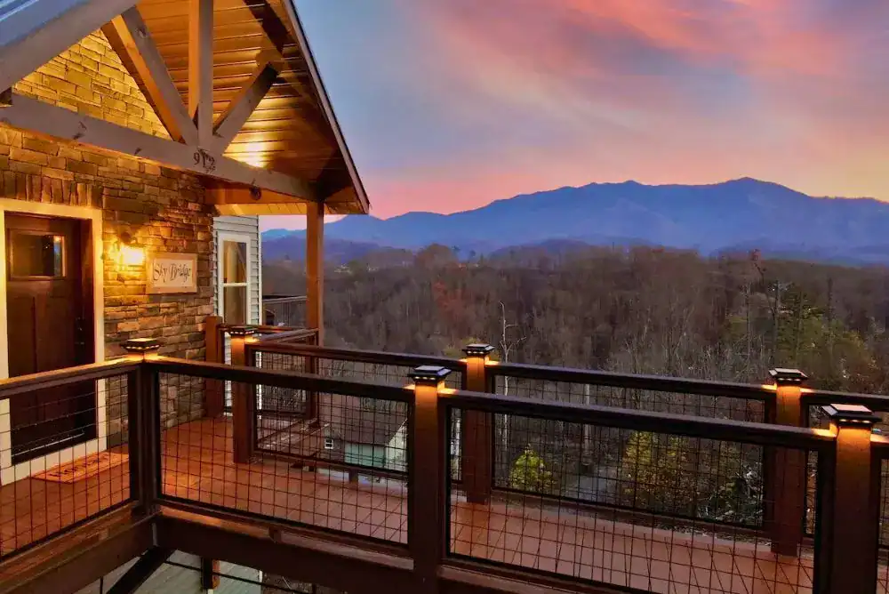 Smoky Mountain cabin with a deck overlooking the mountains at sunset