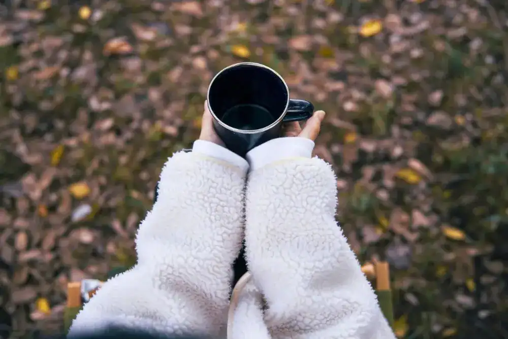 Hot coffee on a chilly morning with a few favorite fall camping essentials.