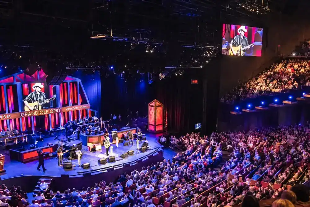 Grand Ole Opry live country music performance in Nashville, Tennessee, with musicians onstage and a full audience.