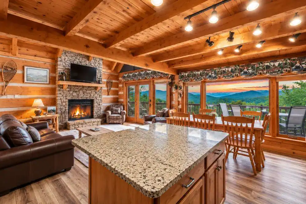 Hiking Bear Cabin in Townsend, Tennessee, featuring a log cabin living room with stone fireplace, leather seating, kitchen island, and large windows.