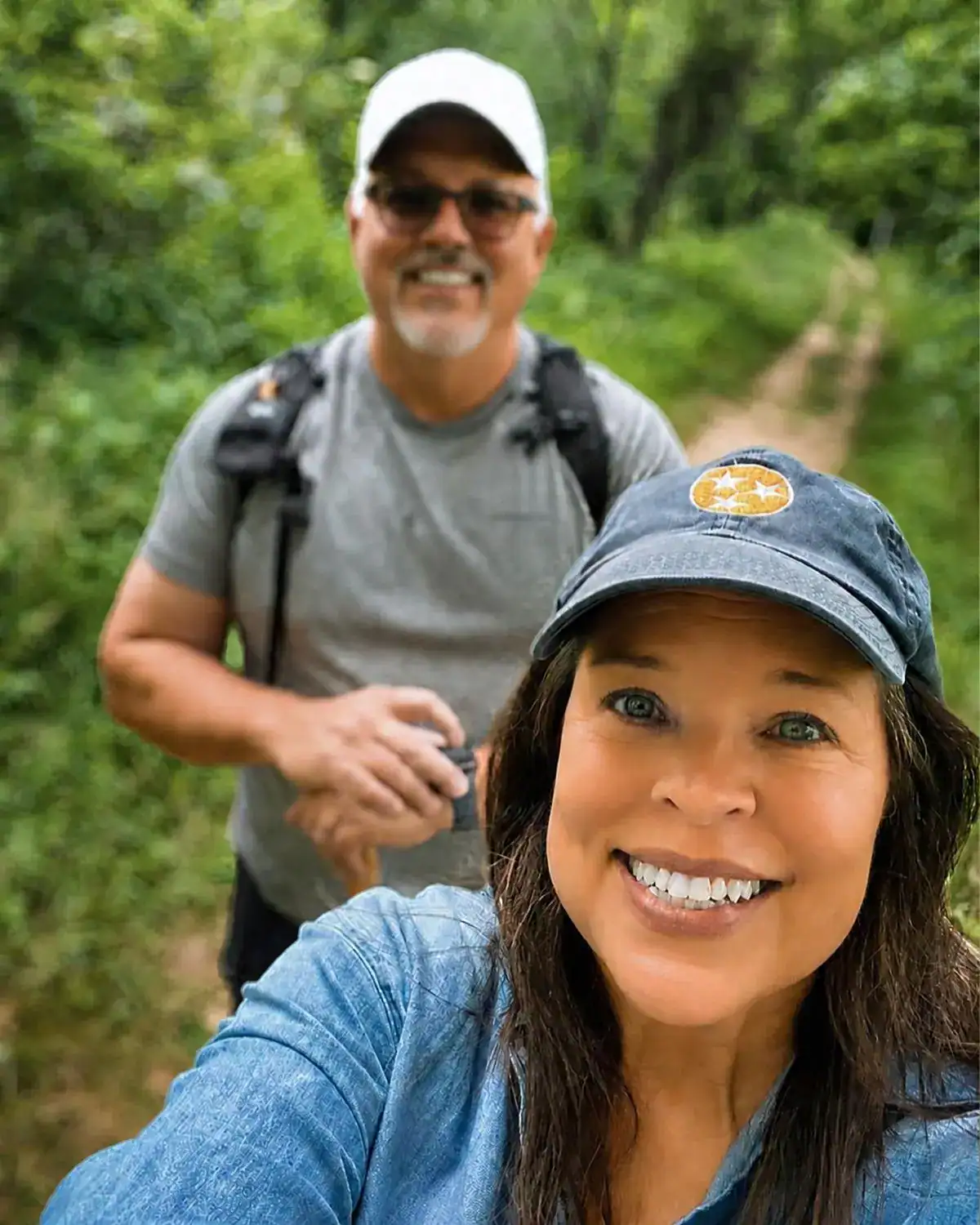 Angela and her husband hiking a Tennessee trail