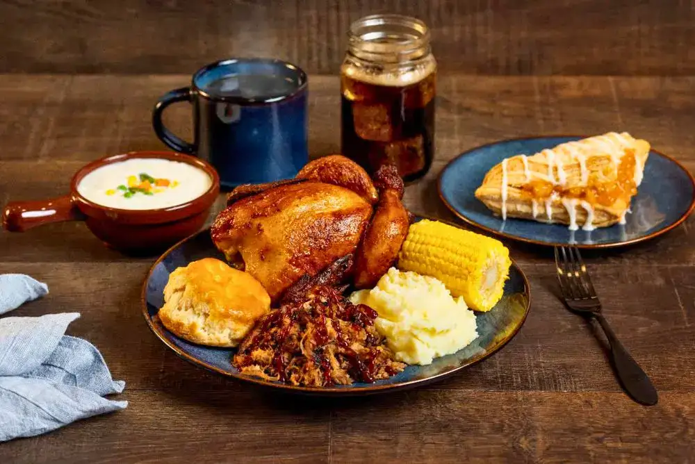 Four-course dinner at Dolly Parton's Stampede in Pigeon Forge with chicken, pulled pork, corn, potatoes, biscuit, soup, and dessert.